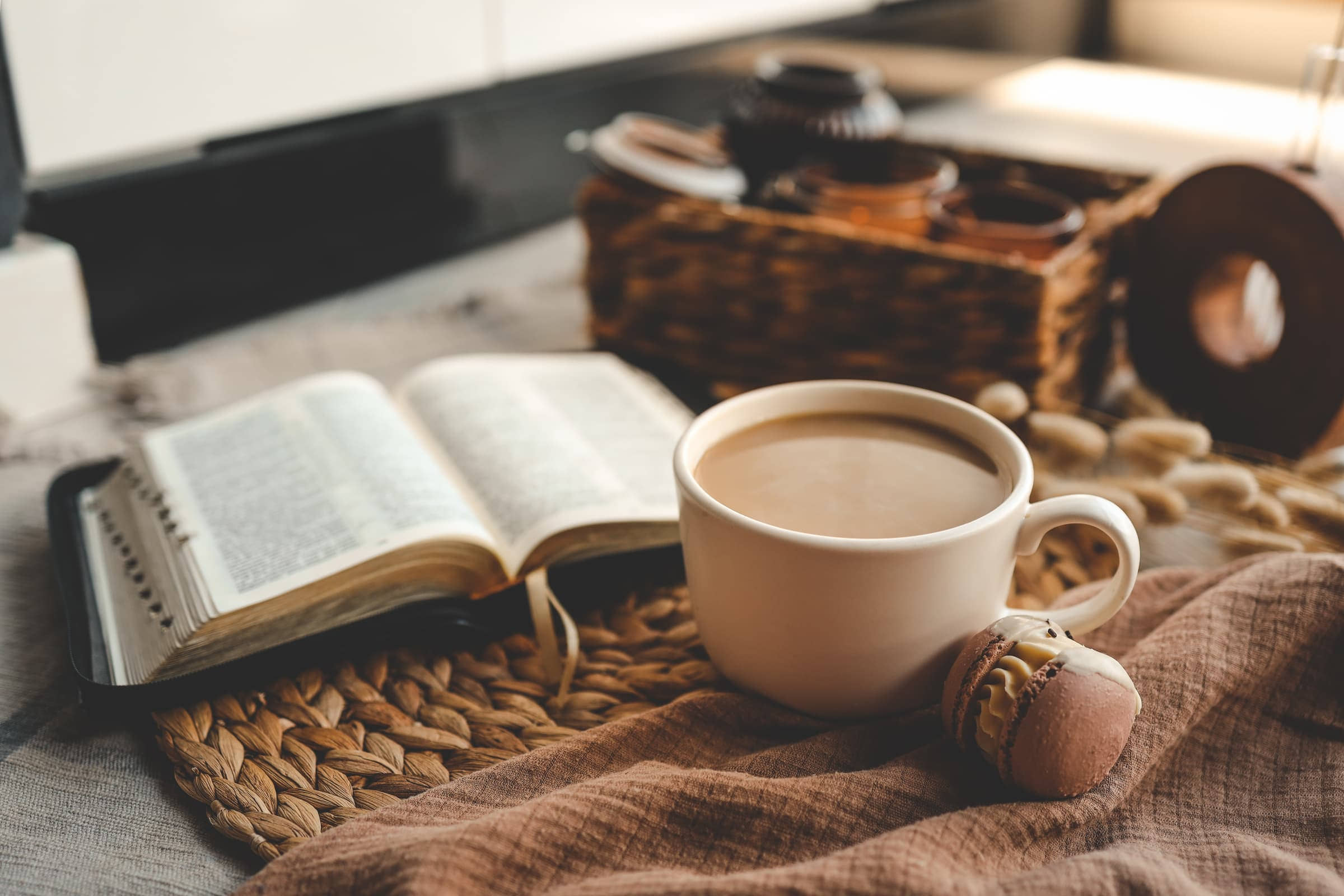 Open Bible beside a cup of coffee